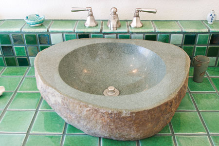 A hollowed out granite sink bowl and Fire and Earth tile were perfect additions to the bathroom.